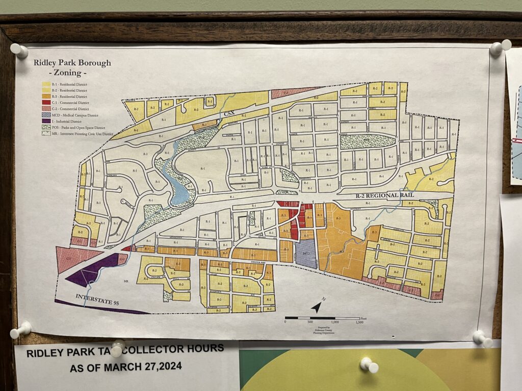 A close up of a zoning map hanging on a bulletin board