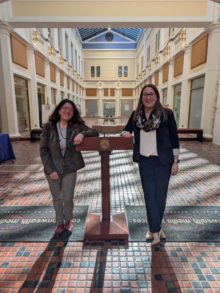 Two woman stand in the interior of the Pennsylvania Capitol